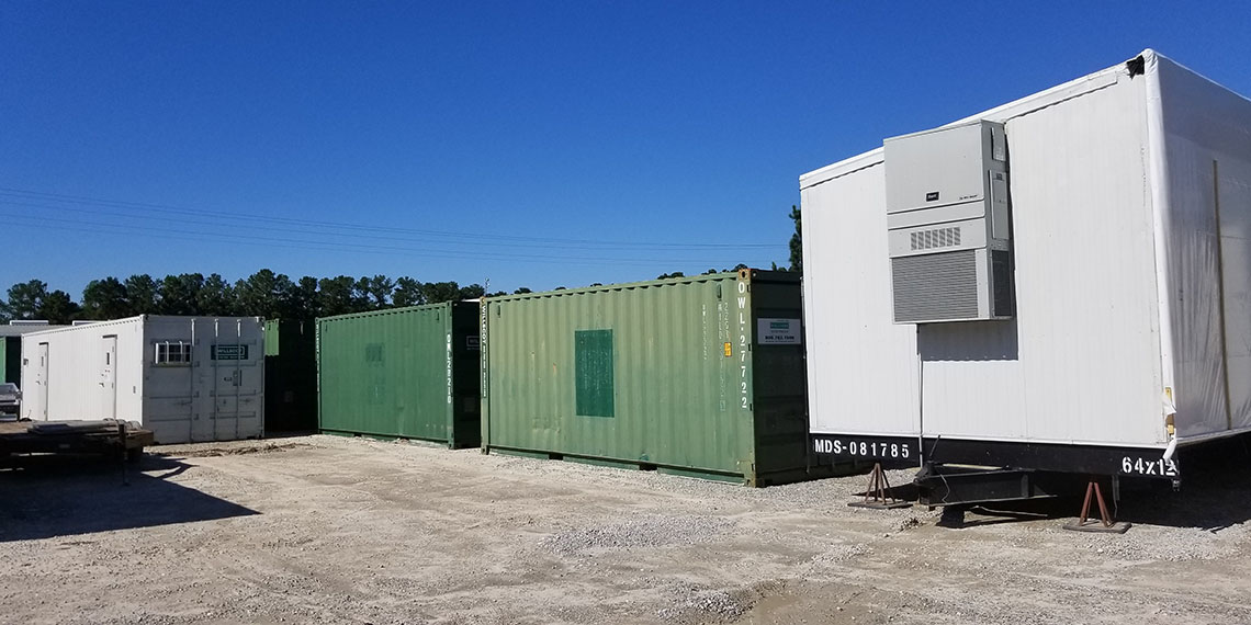various types of containers next to a portable trailer at WillScot Charleston, SC 